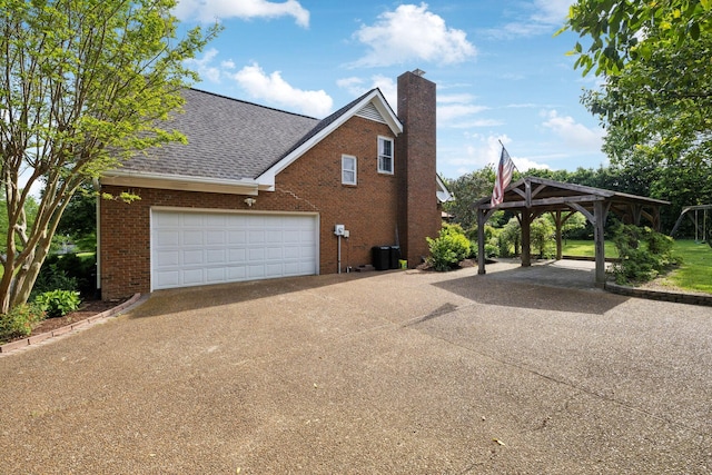 view of property exterior featuring a chimney, central air condition unit, brick siding, concrete driveway, and a shingled roof