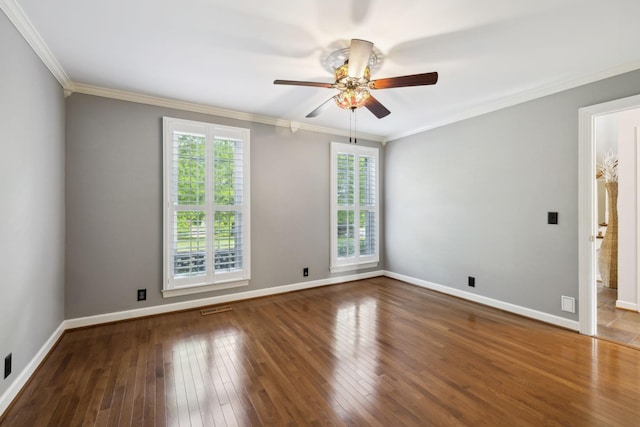 unfurnished room with crown molding, hardwood / wood-style floors, a ceiling fan, baseboards, and visible vents