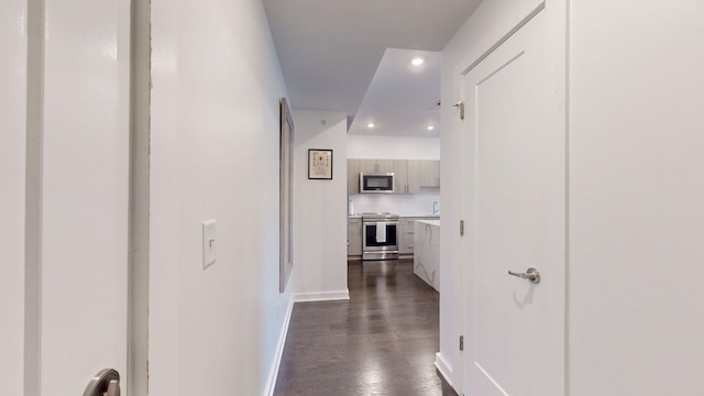 corridor with recessed lighting, baseboards, and dark wood-style flooring