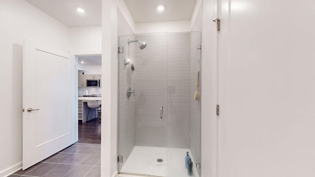 bathroom with tile patterned flooring, a shower stall, and recessed lighting
