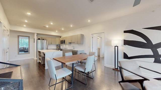 dining room featuring dark wood-type flooring, recessed lighting, and baseboards