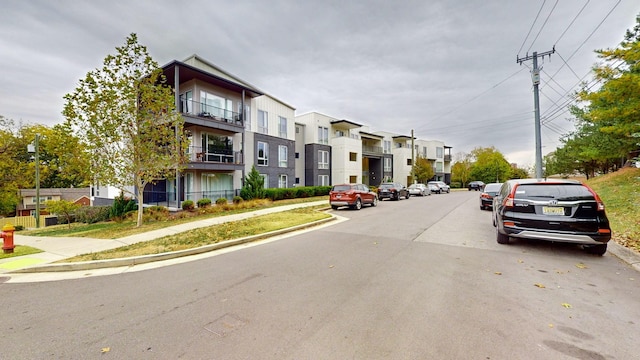 view of street with street lights, sidewalks, and curbs