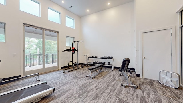exercise area with a high ceiling, recessed lighting, and visible vents