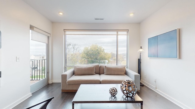 living room featuring recessed lighting, baseboards, visible vents, and wood finished floors