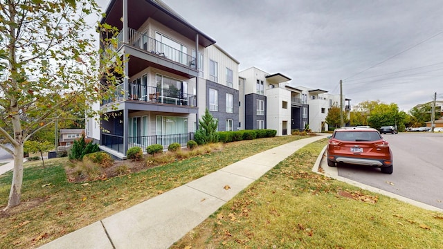 view of road with a residential view, sidewalks, and curbs