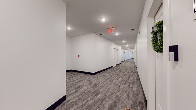 corridor featuring recessed lighting, baseboards, and wood finished floors