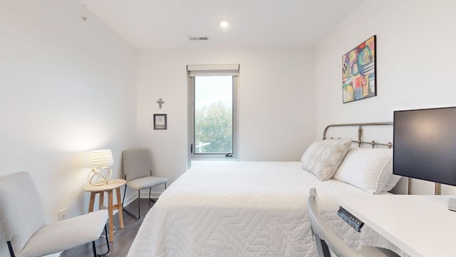 bedroom featuring visible vents, recessed lighting, baseboards, and wood finished floors