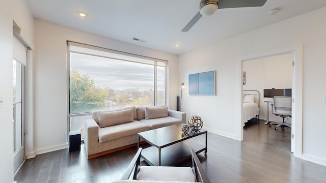 living area featuring ceiling fan, visible vents, a healthy amount of sunlight, and wood finished floors