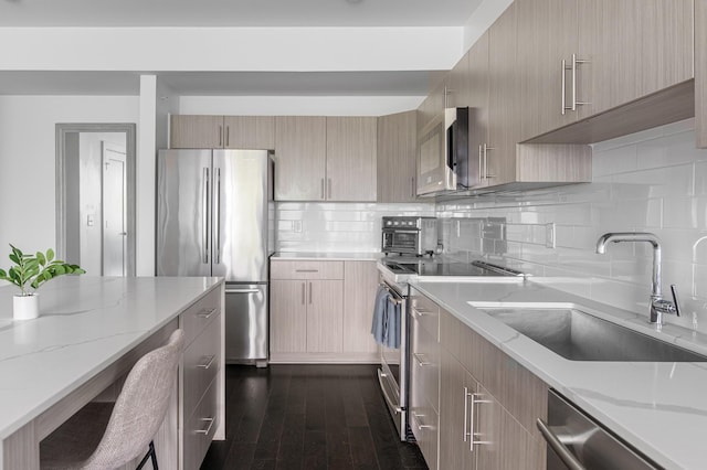 3116 W End Cir Unit 310, Nashville, TN 37203 - kitchen featuring appliances with stainless steel finishes, a sink, light stone countertops, tasteful backsplash, and modern cabinets
