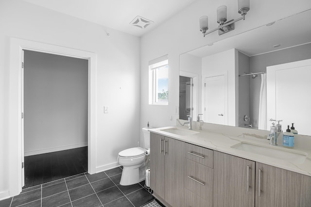 3116 W End Cir Unit 310, Nashville, TN 37203 - bathroom with toilet, double vanity, tile patterned flooring, baseboards, and a shower