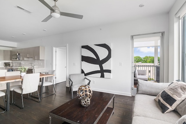 3116 W End Cir Unit 310, Nashville, TN 37203 - living room with healthy amount of natural light, ceiling fan, dark wood-style flooring, and baseboards