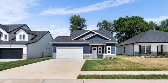 1413 Dan Brown Dr, Clarksville, TN 37042 - view of front of house featuring a shingled roof, an attached garage, a front lawn, stone siding, and concrete driveway