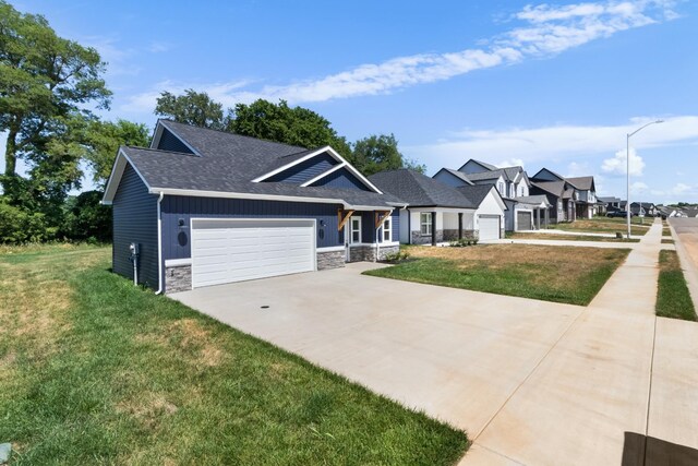 1413 Dan Brown Dr, Clarksville, TN 37042 - craftsman-style home with a garage, driveway, a front lawn, and stone siding