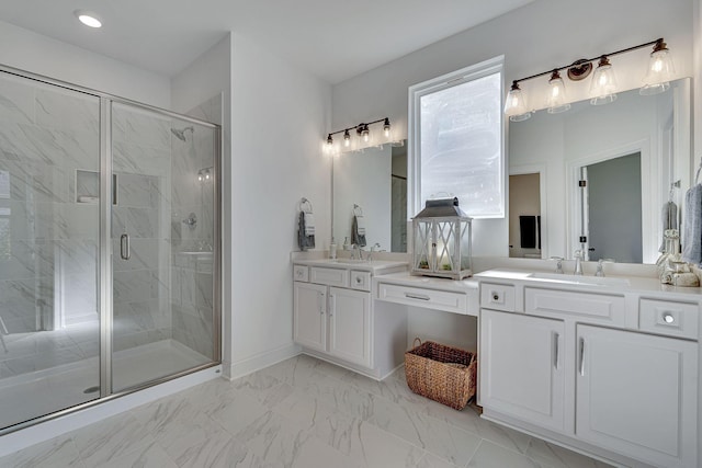 full bathroom with double vanity, a sink, marble finish floor, and a stall shower