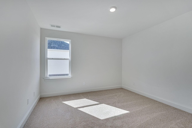 unfurnished room featuring baseboards, carpet flooring, and visible vents