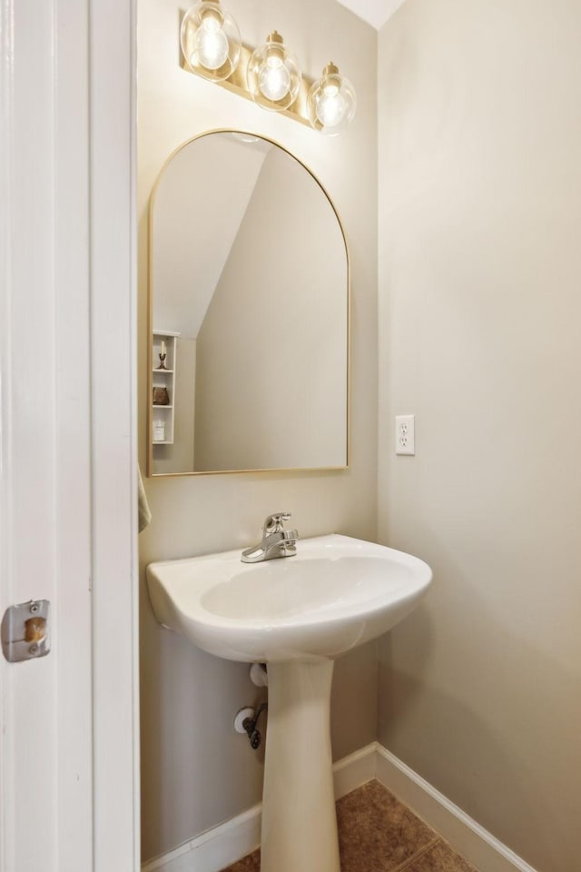 bathroom with baseboards and tile patterned flooring