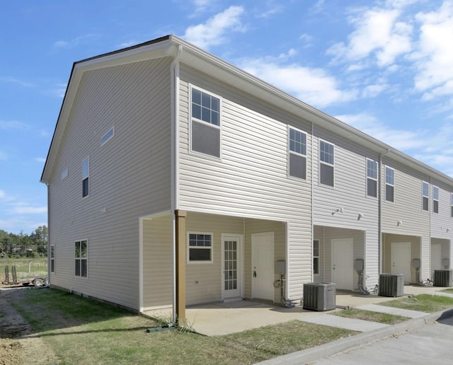 back of property featuring central AC unit and a patio area
