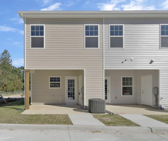 back of house featuring central air condition unit and a patio