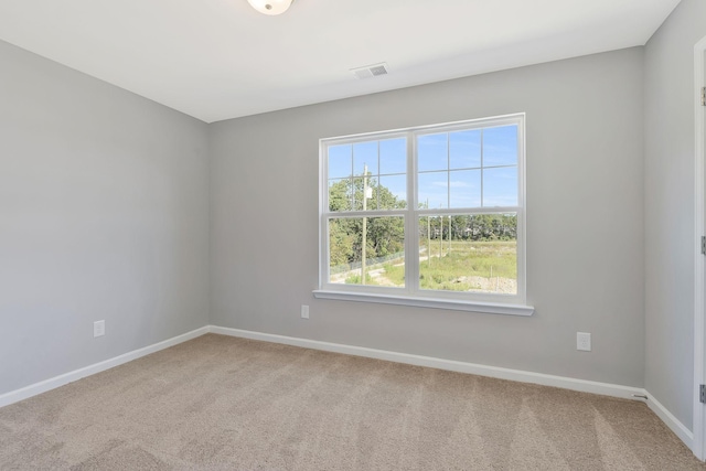 spare room featuring baseboards, carpet, and visible vents