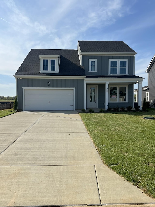 7628 Danswerk Dr, Murfreesboro, TN 37129 - view of front of house with board and batten siding, an attached garage, driveway, and a front lawn