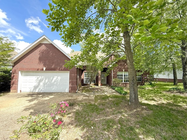 view of front of home with brick siding, driveway, and a garage