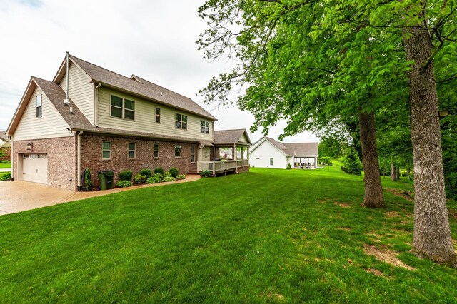 1092 Summerstar Cir, Gallatin, TN 37066 - rear view of property featuring roof with shingles, brick siding, a garage, a lawn, and driveway