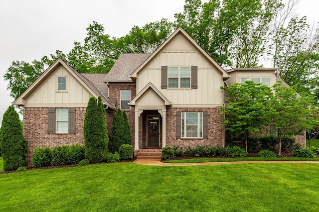 1092 Summerstar Cir, Gallatin, TN 37066 - craftsman house with a shingled roof, board and batten siding, a front yard, and brick siding