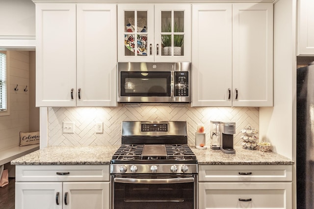 1092 Summerstar Cir, Gallatin, TN 37066 - kitchen featuring appliances with stainless steel finishes, white cabinets, and tasteful backsplash