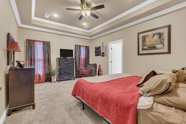 bedroom featuring a ceiling fan, visible vents, ornamental molding, light carpet, and a tray ceiling