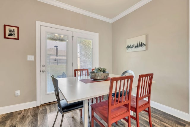 dining room with baseboards, ornamental molding, and dark wood-style flooring