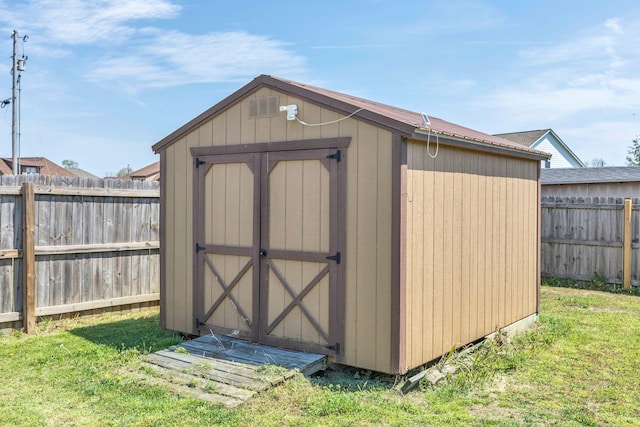 view of shed featuring a fenced backyard