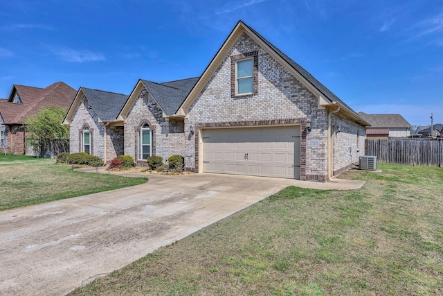 french provincial home with fence, a front lawn, brick siding, concrete driveway, and cooling unit
