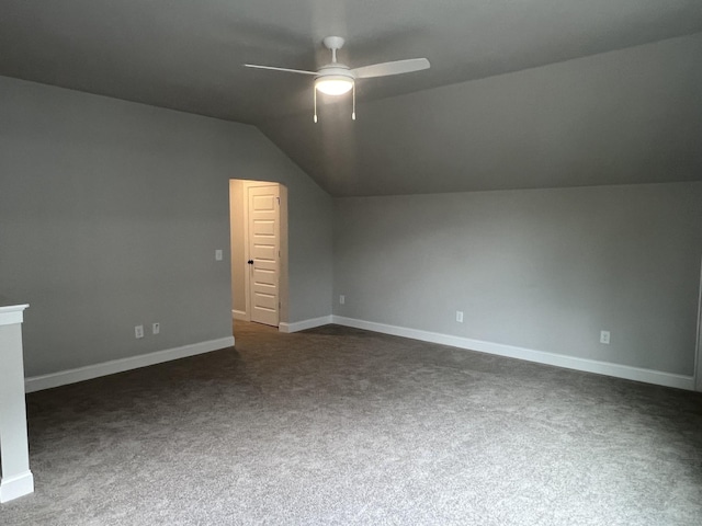 bonus room with baseboards, ceiling fan, dark colored carpet, and lofted ceiling