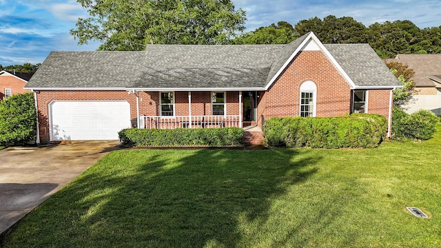 103 Hillcrest Dr, Tullahoma, TN 37388 - view of front facade featuring brick siding, roof with shingles, a front lawn, covered porch, and concrete driveway