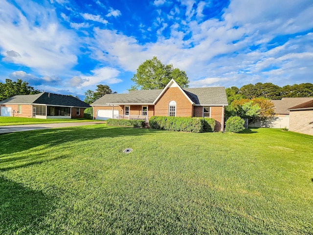 103 Hillcrest Dr, Tullahoma, TN 37388 - single story home with driveway, brick siding, a front lawn, a garage, and covered porch
