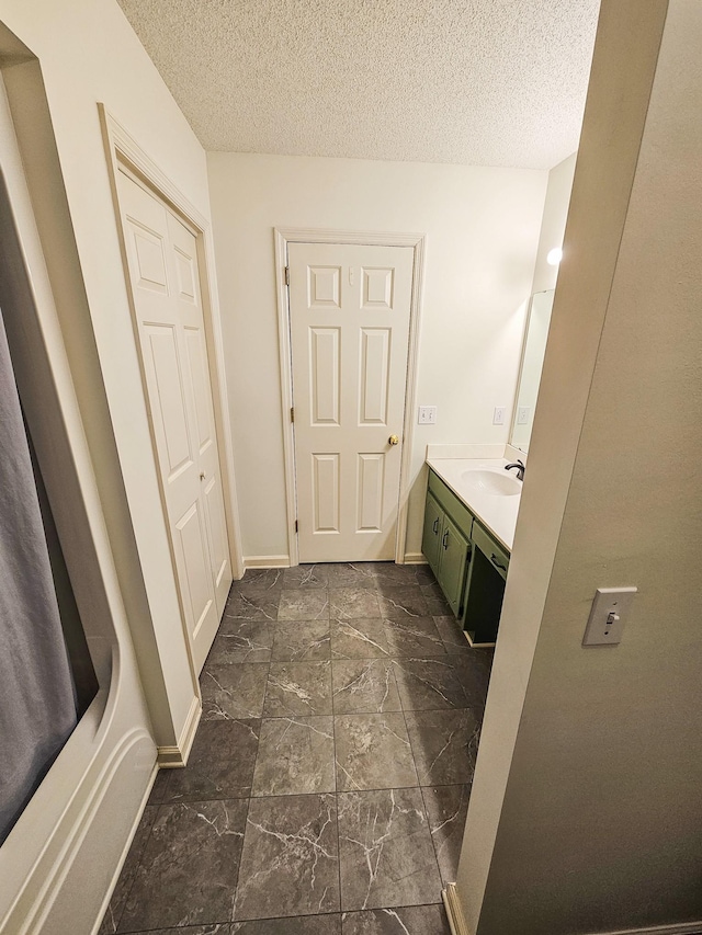 103 Hillcrest Dr, Tullahoma, TN 37388 - bathroom with vanity, marble finish floors, a textured ceiling, and baseboards