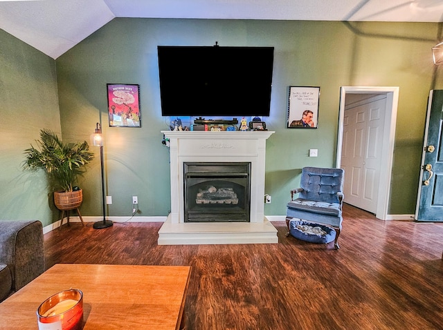 103 Hillcrest Dr, Tullahoma, TN 37388 - living room featuring wood finished floors, lofted ceiling, a fireplace with raised hearth, and baseboards