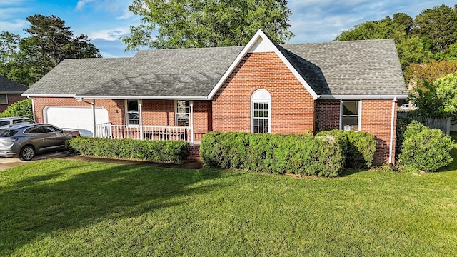 103 Hillcrest Dr, Tullahoma, TN 37388 - view of front facade featuring a shingled roof, brick siding, a garage, covered porch, and a front lawn