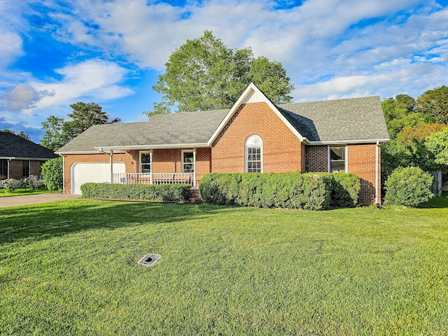 103 Hillcrest Dr, Tullahoma, TN 37388 - view of front facade featuring brick siding, a front yard, and an attached garage