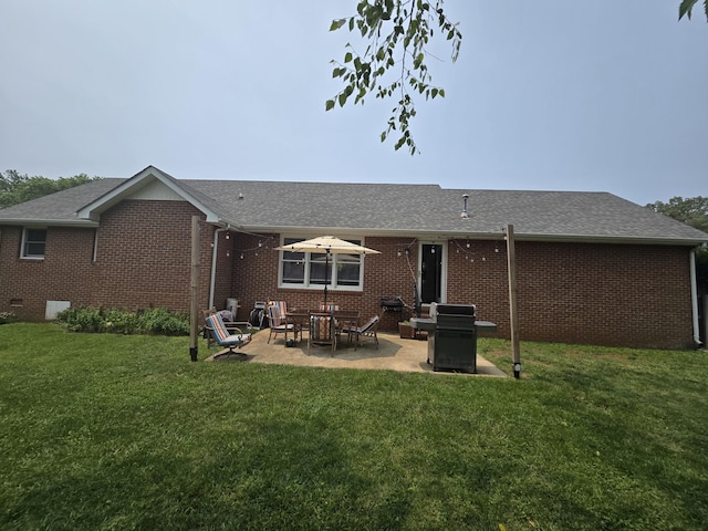 103 Hillcrest Dr, Tullahoma, TN 37388 - rear view of house featuring brick siding, a patio, a lawn, and a shingled roof