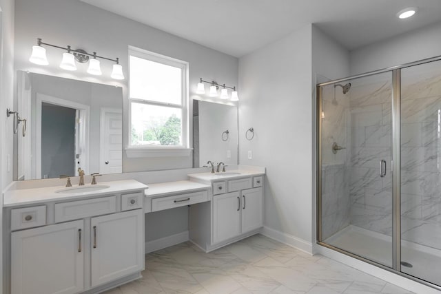full bathroom with double vanity, a sink, marble finish floor, and a marble finish shower