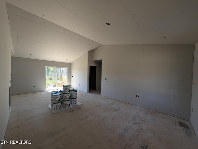 unfurnished living room featuring vaulted ceiling