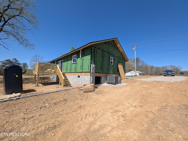 exterior space with crawl space, central AC, a wooden deck, and stairs