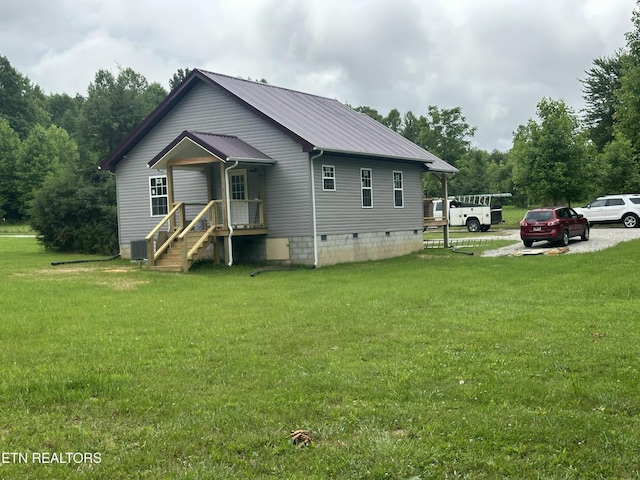 1173 Terry Ln, Jamestown, TN 38556 - back of property with a metal roof, crawl space, and a lawn
