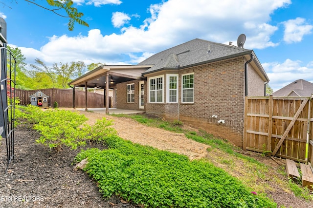 8508 Flowering Peach Ln, Knoxville, TN 37923 - rear view of property with ceiling fan, a patio, a fenced backyard, brick siding, and a gate