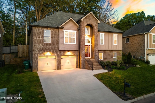 8508 Flowering Peach Ln, Knoxville, TN 37923 - bi-level home featuring a garage, a front yard, brick siding, board and batten siding, and driveway
