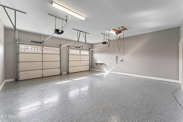 8508 Flowering Peach Ln, Knoxville, TN 37923 - garage featuring baseboards and a garage door opener