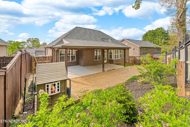 8508 Flowering Peach Ln, Knoxville, TN 37923 - back of house featuring roof with shingles, brick siding, a fenced backyard, a gate, and a patio