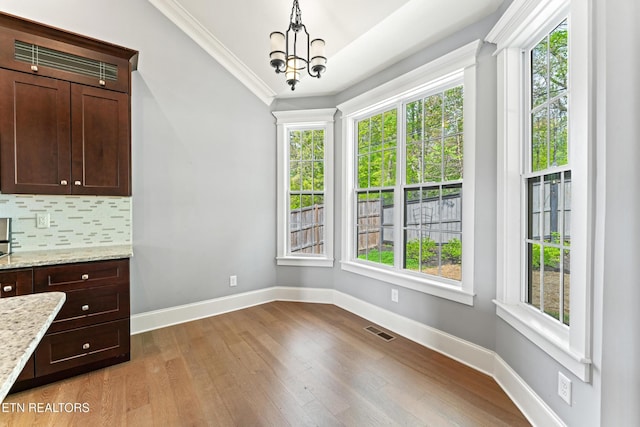 8508 Flowering Peach Ln, Knoxville, TN 37923 - unfurnished dining area with visible vents, an inviting chandelier, baseboards, plenty of natural light, and light wood-type flooring