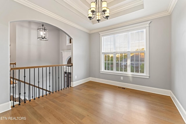 8508 Flowering Peach Ln, Knoxville, TN 37923 - empty room with wood-type flooring, arched walkways, a chandelier, and visible vents